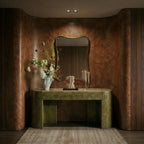 The Clérachic black two-head recessed downlight glowing warm white above a wood console with an arched mirror.