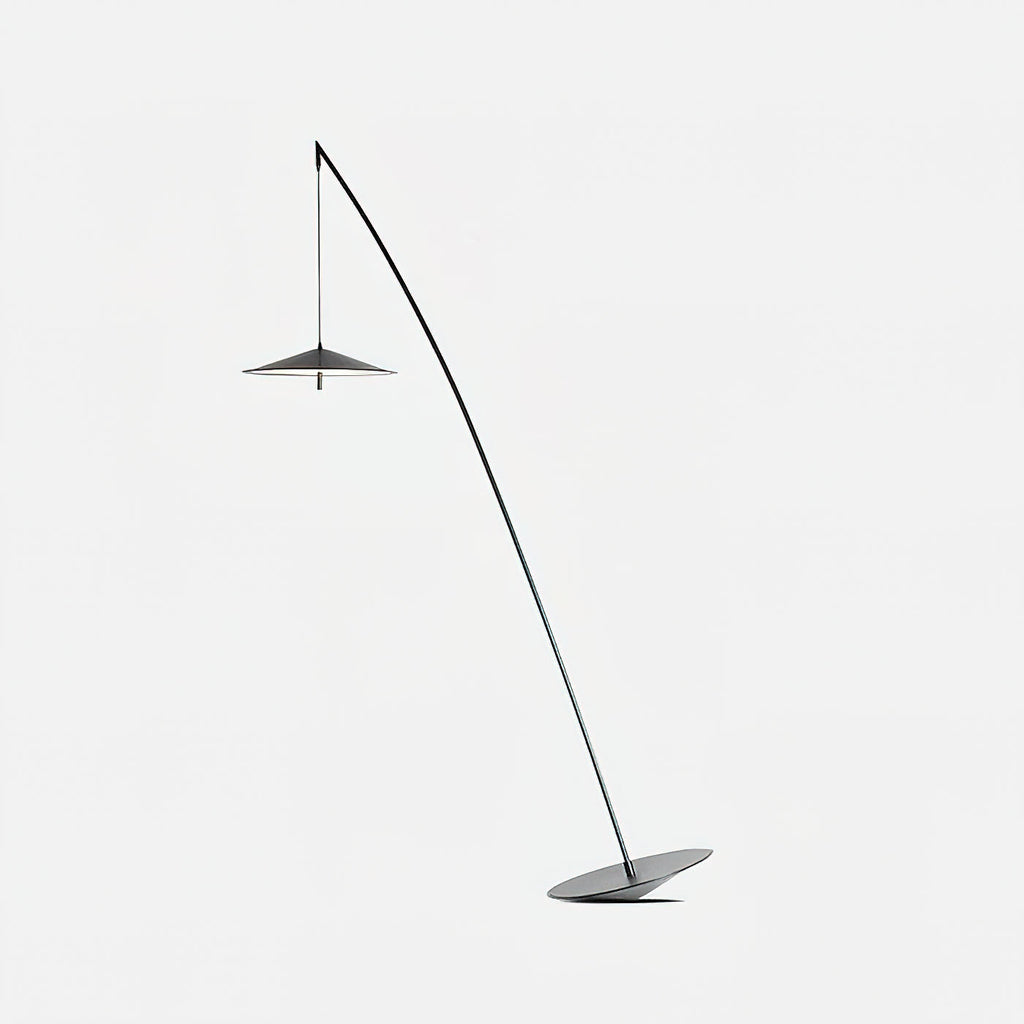 Floor lamp in black with a fine curved stem and a small disc shade, on a soft light-grey background, from Clérachic.
