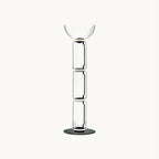 Clérachic floor lamp on a plain white backdrop, three stacked clear glass cylinders topped by a wide glass bowl on a round black base.