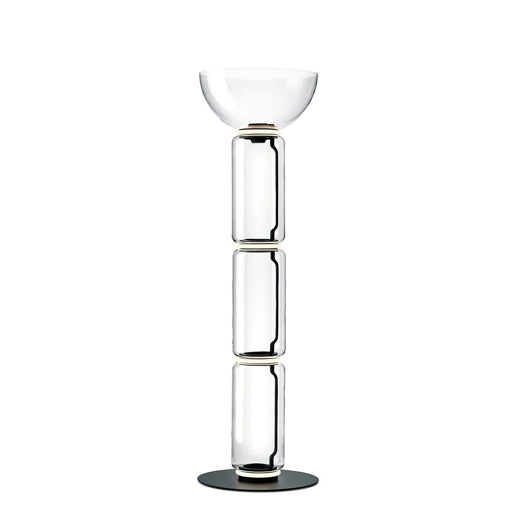 Clérachic floor lamp on white, three clear glass cylinders under a wide glass bowl, on a flat round black base.