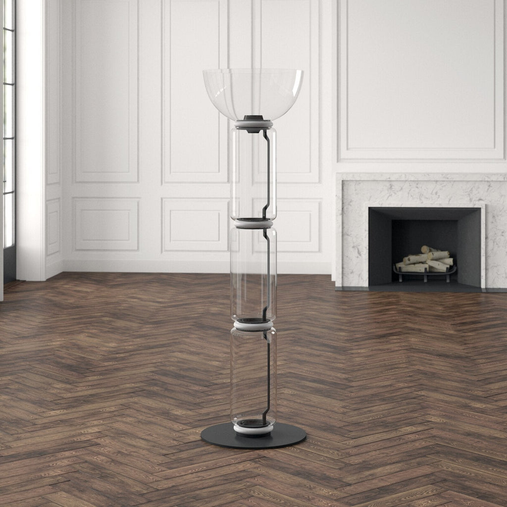 Clérachic floor lamp with a wide glass bowl on top, unlit, in a panelled room with a marble fireplace and a herringbone floor.