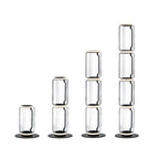 Four Clérachic floor lamps in rising heights on white, built from one to four stacked glass cylinders with round black bases.