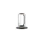Single-cylinder Clérachic floor lamp on white, a clear glass drum with a glowing ring on a round black base.