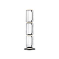 Clérachic floor lamp on white, three stacked clear glass cylinders with glowing rings at each join and a round black base.