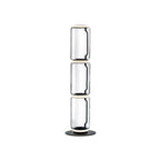 Clérachic floor lamp on white, three stacked clear glass cylinders with glowing rings at each join and a round black base.