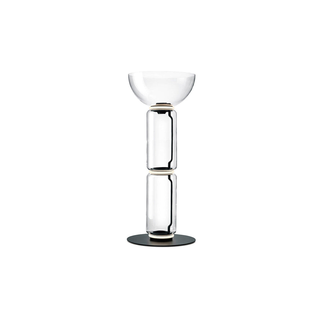 Clérachic floor lamp on a white backdrop, two glass cylinders under a wide glass bowl, on a round black base.