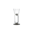 Clérachic floor lamp on white, a clear glass cylinder under a tall flared glass top, on a round black base.
