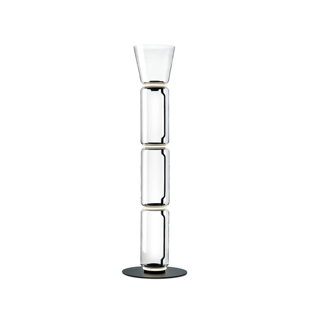 Clérachic floor lamp on white, three stacked glass cylinders under a small flared glass top, on a round black base.