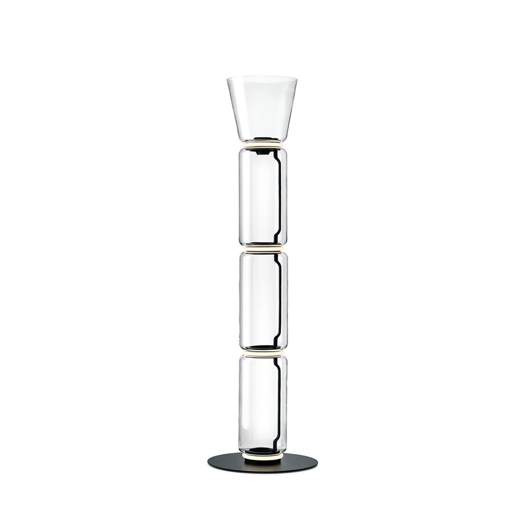 Clérachic floor lamp on white, three stacked glass cylinders under a small flared glass top, on a round black base.
