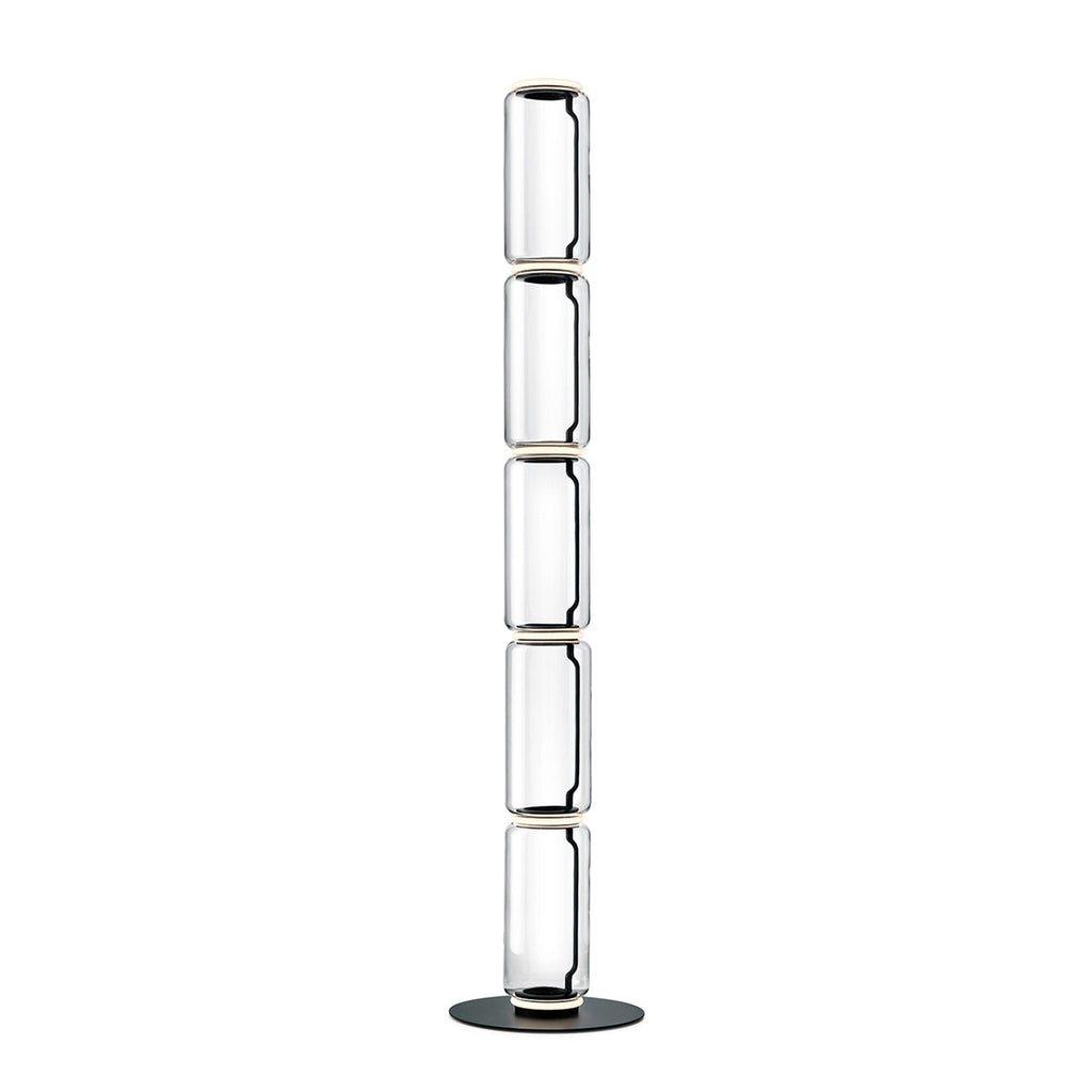 Very tall Clérachic floor lamp on white, five stacked clear glass cylinders with light rings and a round black base.