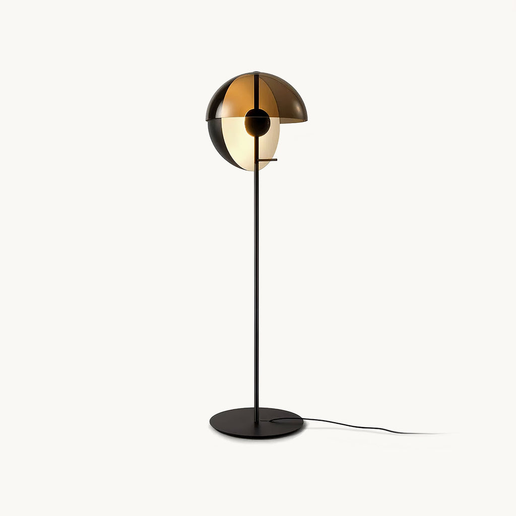 Black floor lamp from Clérachic with a split dome shade in smoked bronze over a pale inner globe, on a slim stem and round base.
