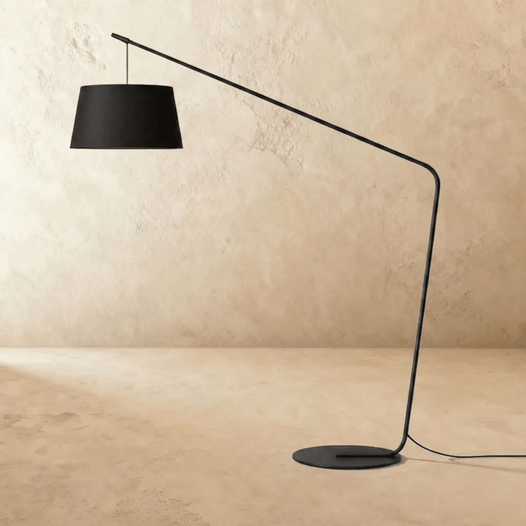Clérachic arc floor lamp with the black tapered fabric shade unlit, on a slim black stem and flat round base.
