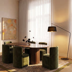 Clérachic black arc floor lamp with a fabric shade glowing beside sheer curtains and an olive velvet dining set.
