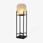 This Clérachic solar floor lantern on a plain white backdrop, with a rounded frosted glass shade on a tall black open frame.