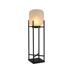 Tall Clérachic lantern lit on a white background, seen at a slight angle, with a frosted shade and square base.