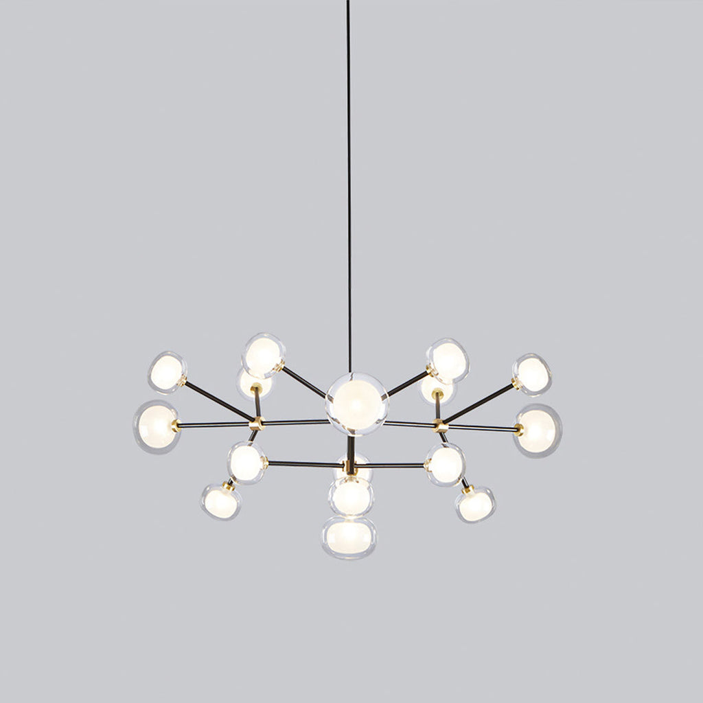 Clérachic chandelier on a grey backdrop, shown from the side with its two tiers of glass globes spread wide beneath the black rod.