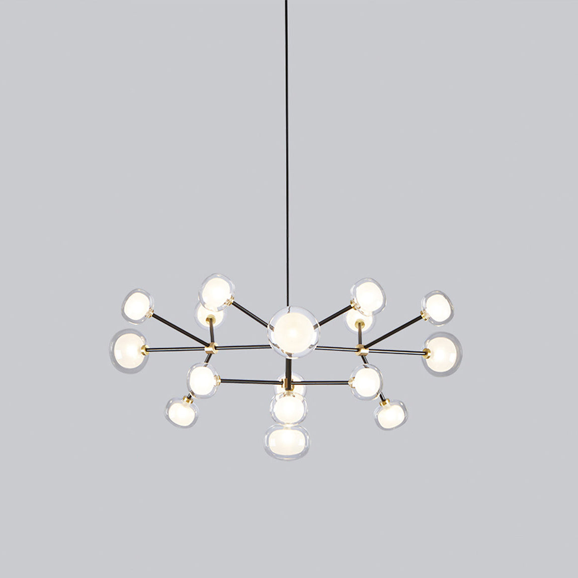 Clérachic chandelier on a grey backdrop, shown from the side with its two tiers of glass globes spread wide beneath the black rod.