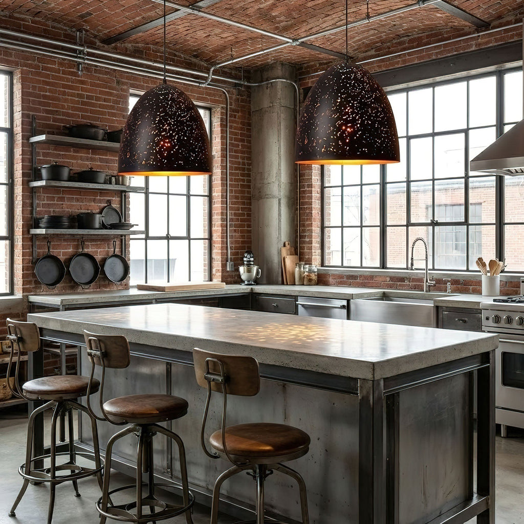 Pair of black domed Clérachic pendants over a concrete kitchen island with metal stools, in front of a brick wall and large windows.
