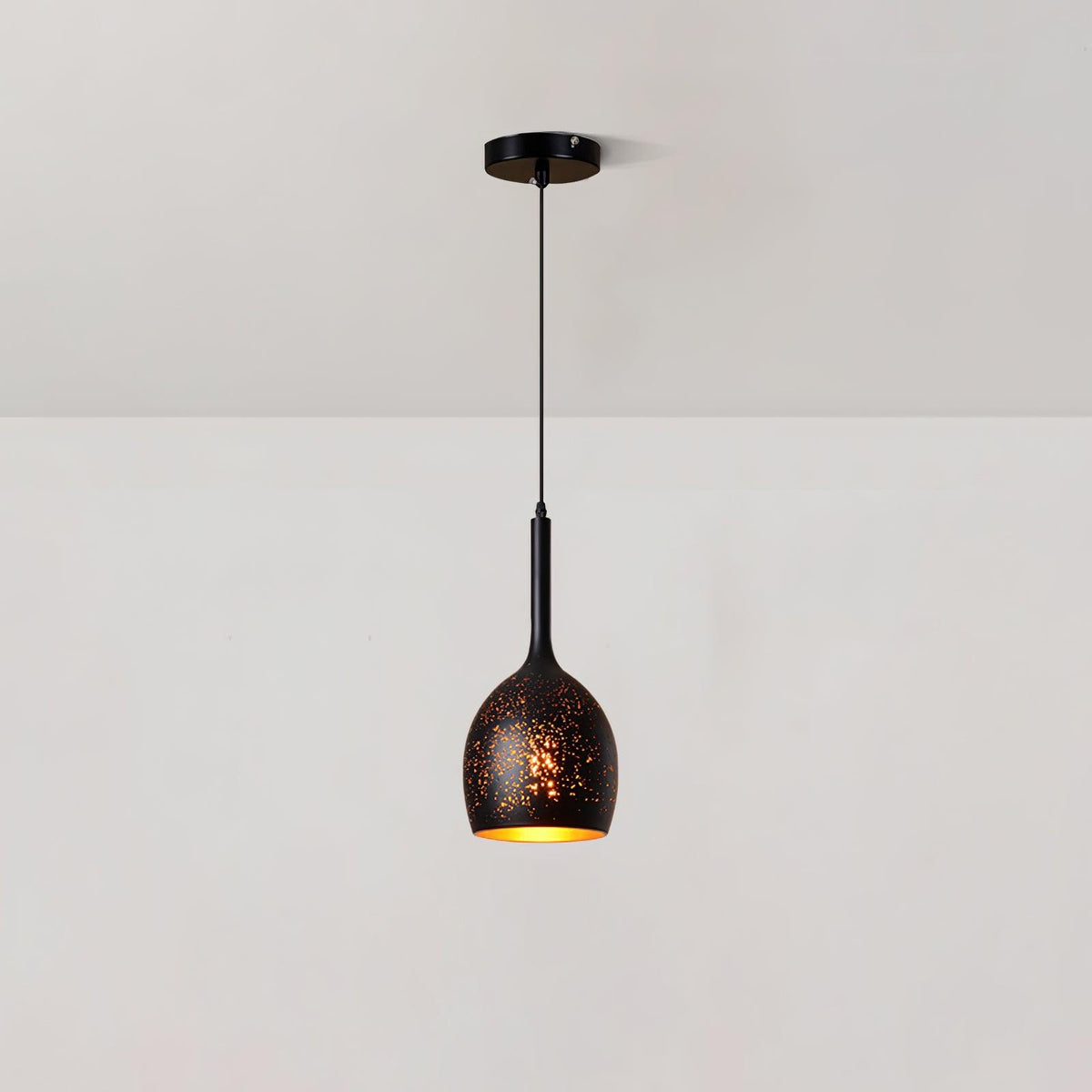 Slim-necked Clérachic pendant with a small egg-shaped black shade, hanging from a ceiling plate against a plain white wall.