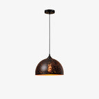 Clérachic dome pendant with a black perforated shade, hanging from a ceiling plate on a thin cord against a plain white backdrop.