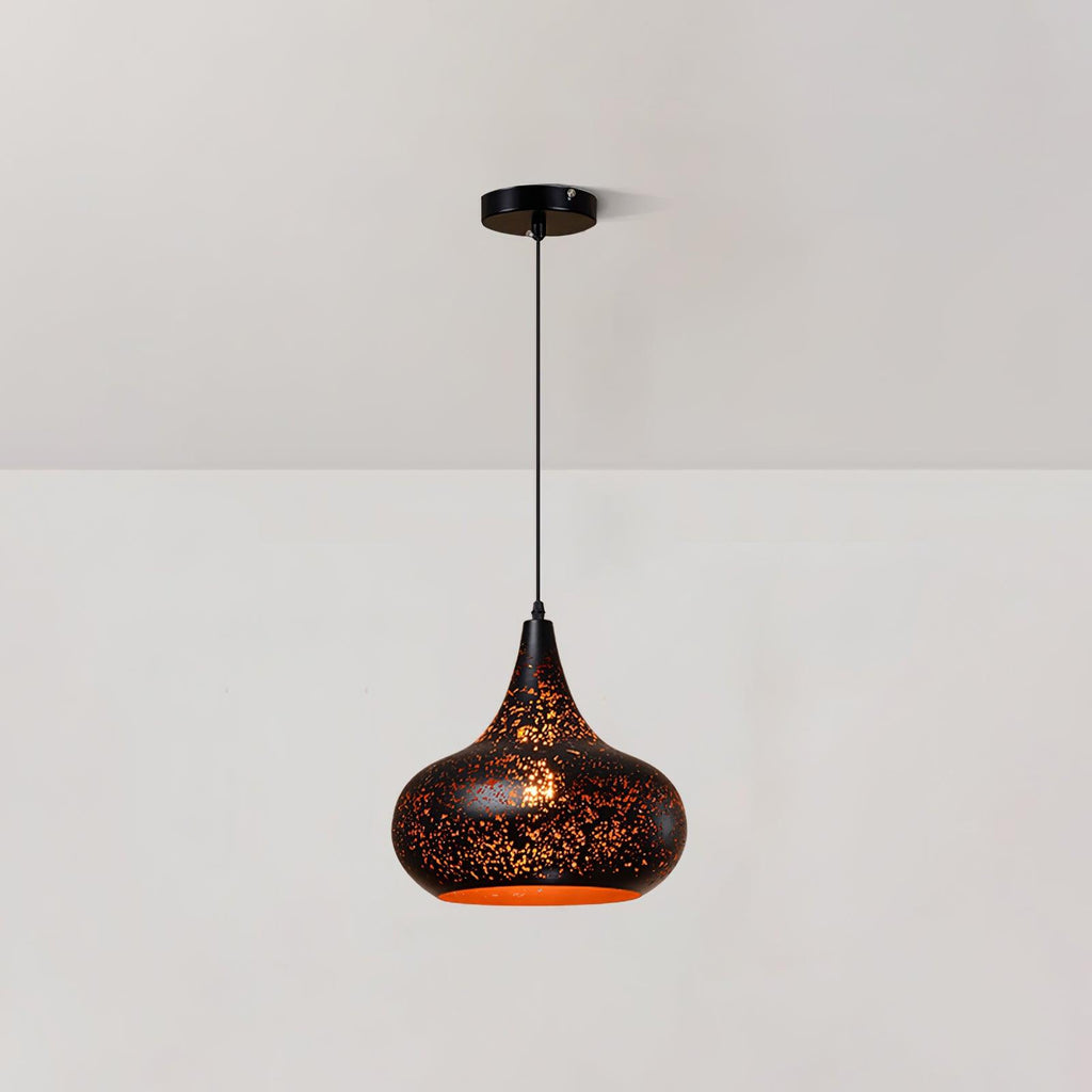 Clérachic pendant with a rounded teardrop shade and a perforated black surface, hanging from a ceiling plate against a pale wall.