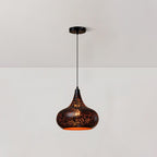 Clérachic pendant with a rounded teardrop shade and a perforated black surface, hanging from a ceiling plate against a pale wall.