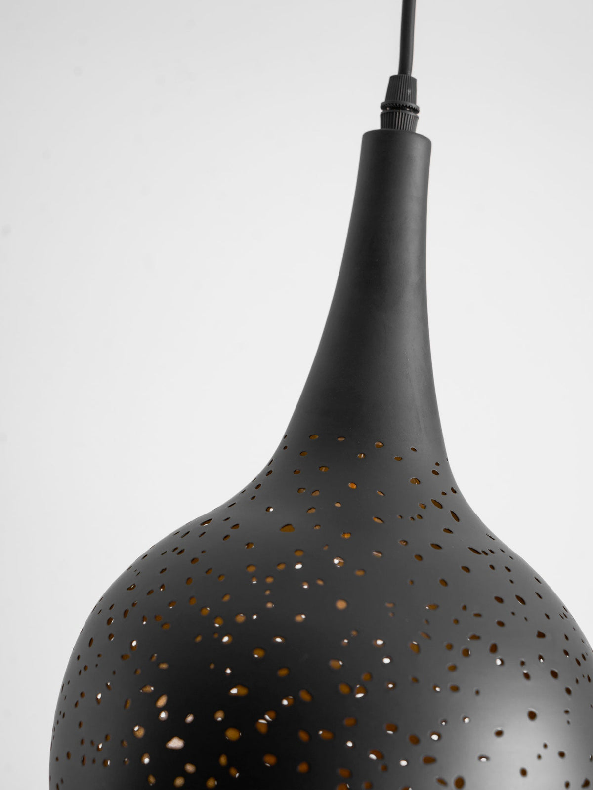 Close view of the slim neck and perforated shoulder of this Clérachic teardrop pendant, in matt black against light grey.