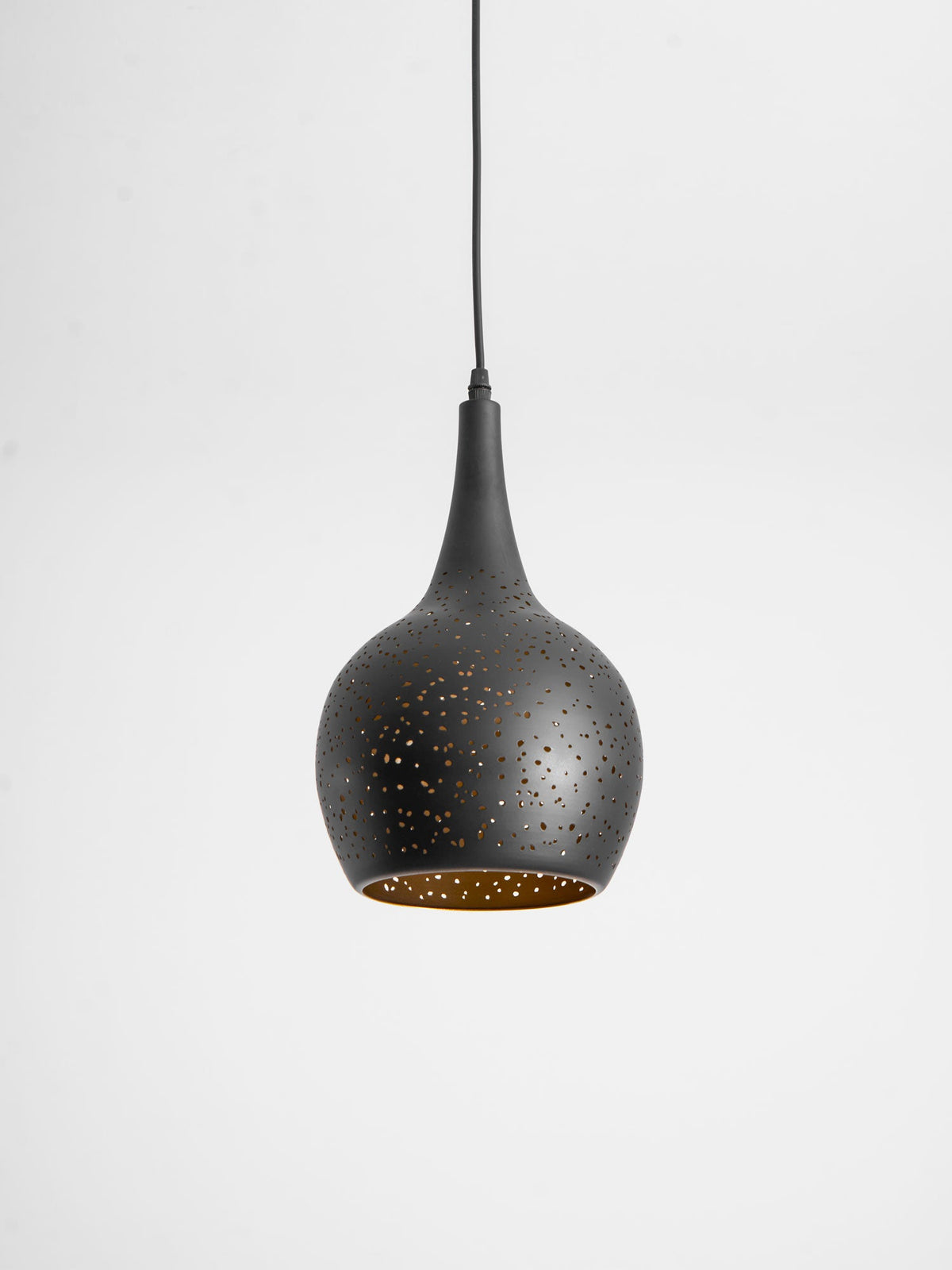 Teardrop Clérachic pendant tilted slightly toward the camera, showing the gold lining inside its perforated black shade.