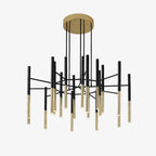 Black arms and gold-finish tubes radiate from a round brass-finish canopy on this Clérachic chandelier, on a pale backdrop.