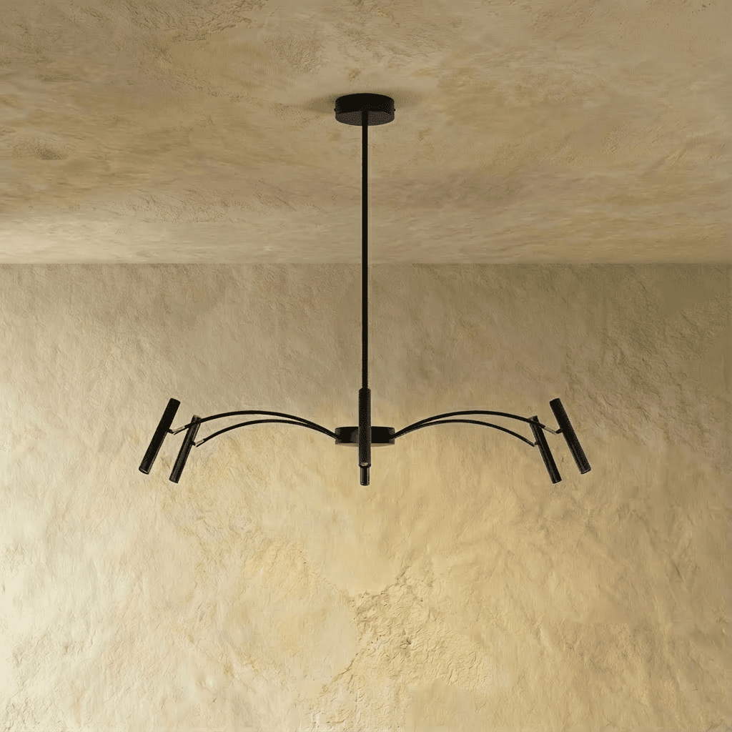 Straight-on view of the black iron chandelier's compact arm spread, its cylinder heads catching light in this Clérachic hero shot.