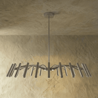 Another angle of the fuller silver-toned chandelier shows its dense arm spread and tube heads against a plain backdrop, Clérachic hero shot.