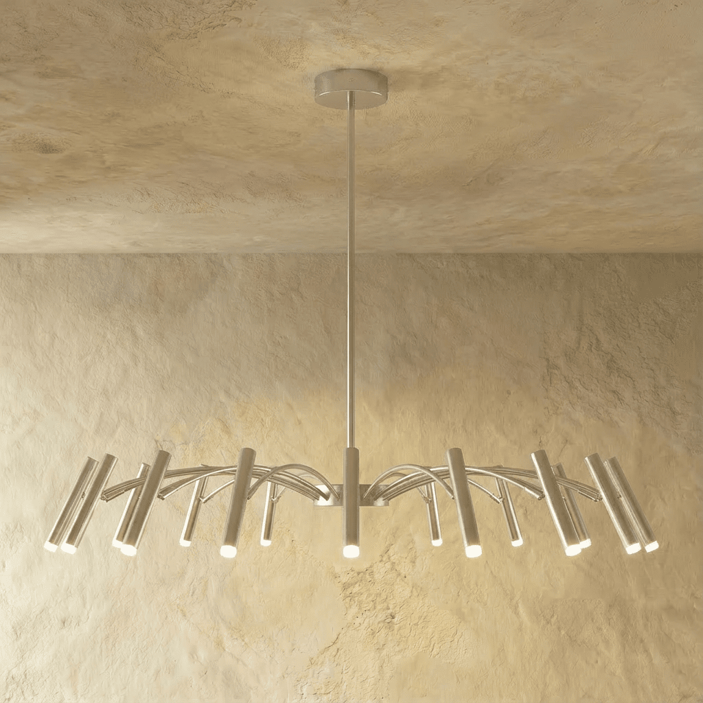 A mid-density silver-toned chandelier fans its arched arms and cylindrical heads across the frame in this Clérachic studio hero shot.