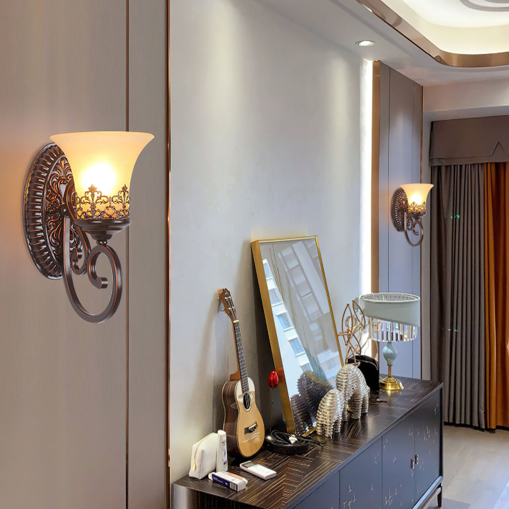 A single-arm Clérachic wall lamp glows in a hallway with a dark console, a ukulele and a gold-framed mirror.