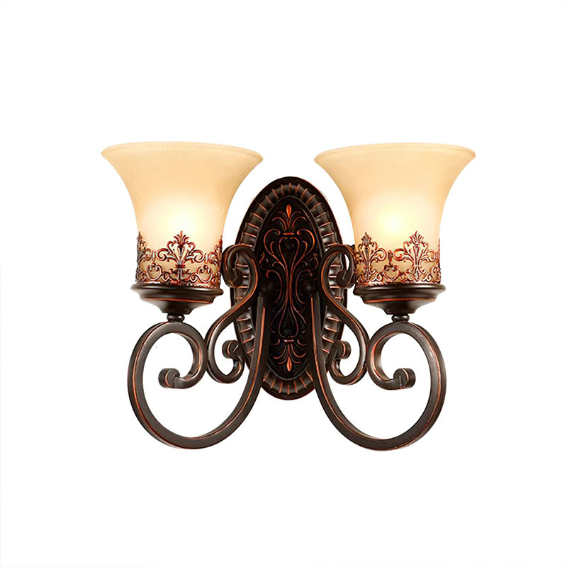 A two-arm Clérachic wall lamp on white, with two cream glass bell shades and a decorative oval backplate.