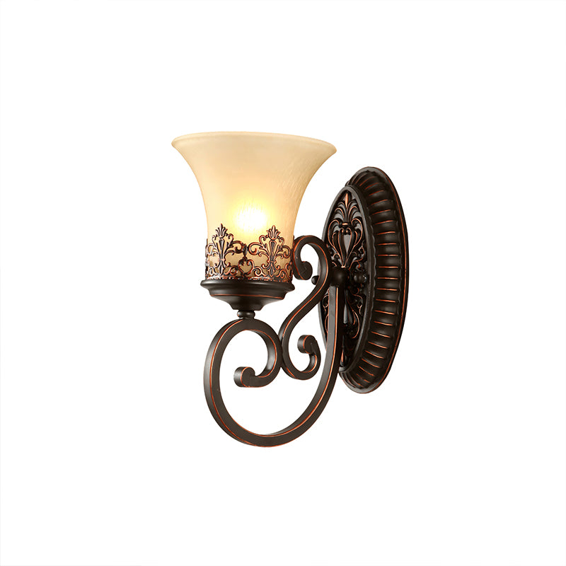 Side view of a single-arm Clérachic wall lamp on white, the scrolled arm curving below its lit bell shade.
