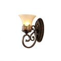 Side view of a single-arm Clérachic wall lamp on white, the scrolled arm curving below its lit bell shade.