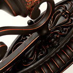 Close view of the fluted oval backplate and the scrolled arms on this Clérachic wall lamp.