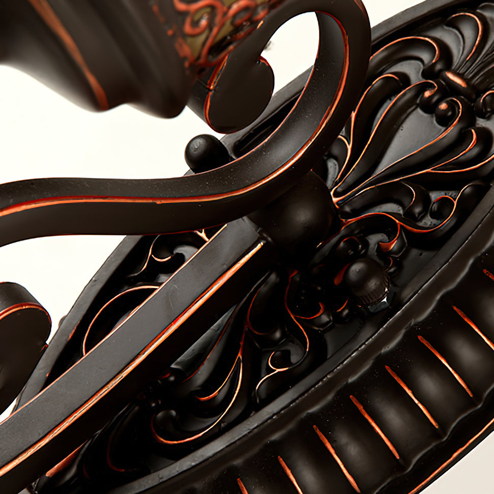 Close view of the fluted oval backplate and the scrolled arms on this Clérachic wall lamp.