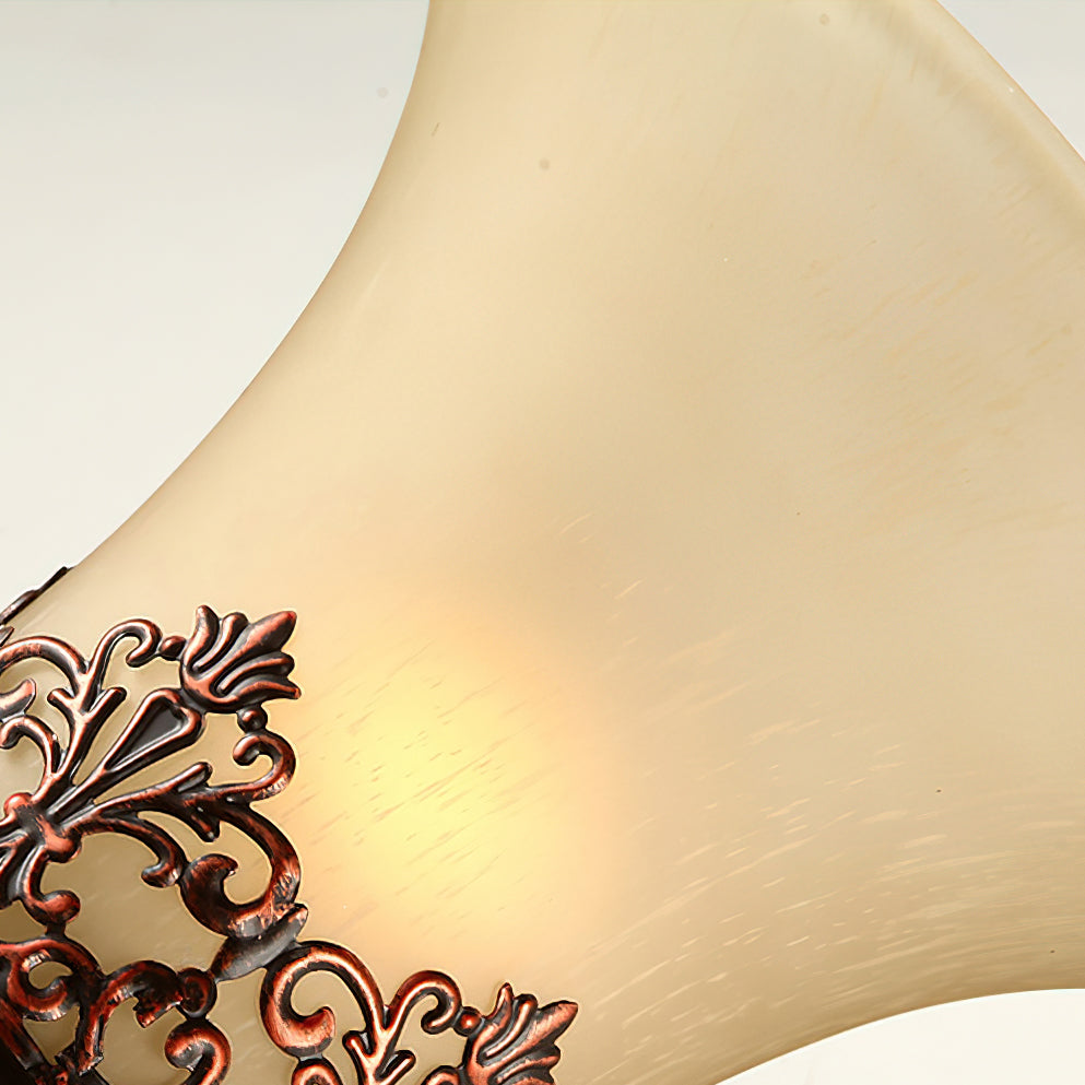 Close view of the frosted cream glass of this Clérachic lamp shade, lit from within, with part of the filigree band below.
