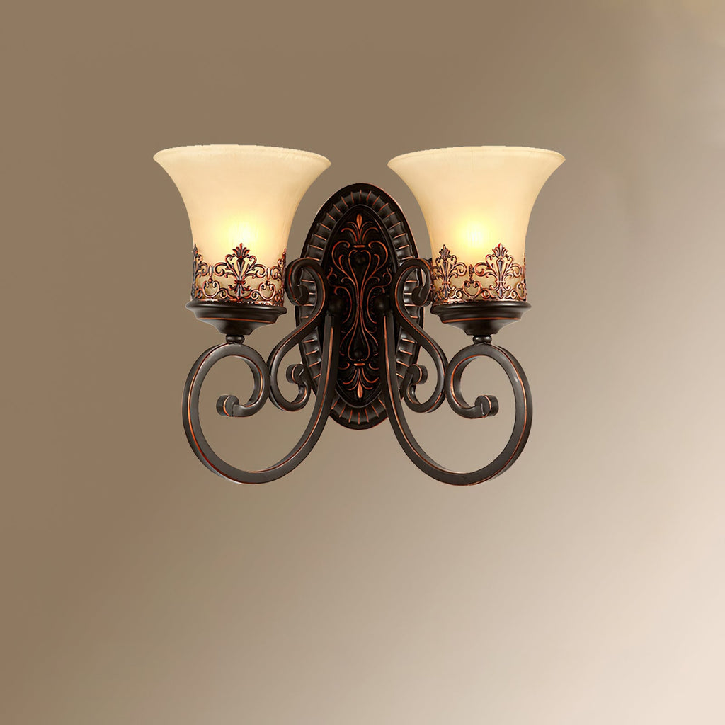 A two-arm Clérachic wall lamp lit against a soft brown-to-cream gradient, with scrolled arms and bell shades.