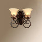 A two-arm Clérachic wall lamp lit against a soft brown-to-cream gradient, with scrolled arms and bell shades.
