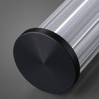 Close view of the black end cap on this Clérachic linear pendant, with fine concentric rings and the ribbed clear tube behind it.