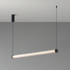 This Clérachic linear pendant hung at a tilt on a grey backdrop, with a black canopy on the left and one cable at each end.