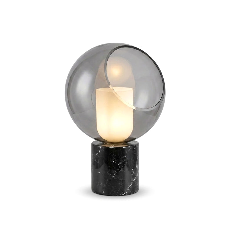 Larger cut-out view of this Clérachic table lamp, the cut-away globe showing the glowing white cylinder over a black marble plinth.