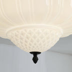 Close view of the quilted lower bowl and black acorn finial on this Clérachic ceiling light.