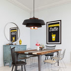 Clérachic pendant light lit, the glow through the shade in a quiet room.