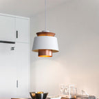 Clérachic pendant light in a room setting over a dining table.