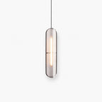Clérachic slim black capsule pendant with a textured shade and a lit LED strip inside, hanging from a thin black cord on white.
