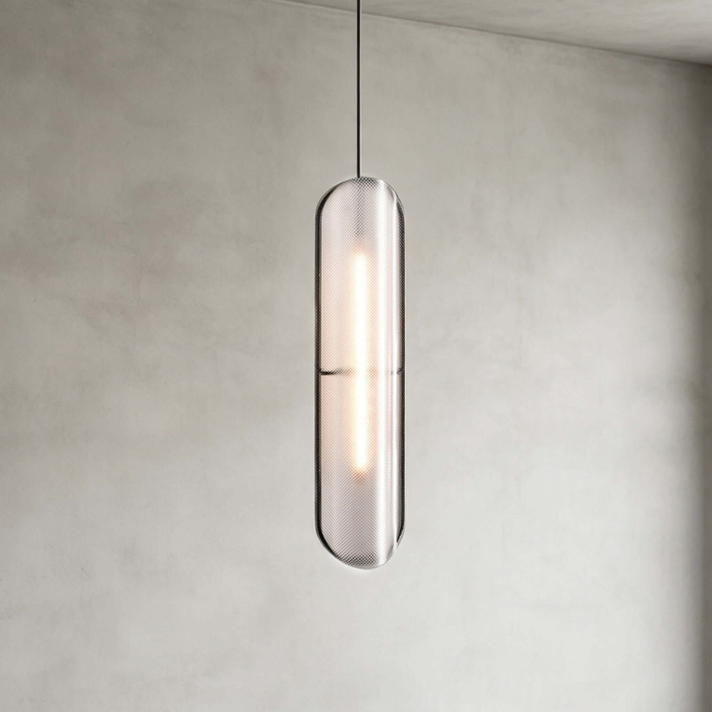 Close view of a Clérachic capsule pendant with a textured grey shade and a lit strip inside, against a plastered wall.