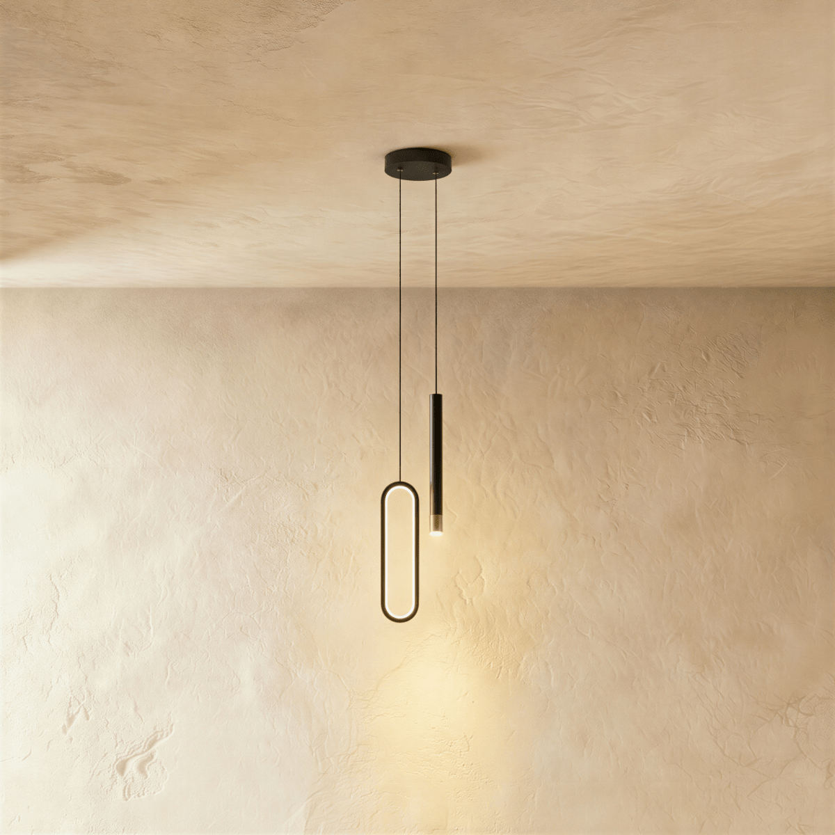 The black pendant's oval ring and cylindrical rod are shown together once more against a bare plaster backdrop, Clérachic hero shot.